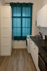 a kitchen with a sink and a washing machine at Central Apartment in Vienna +4 photos