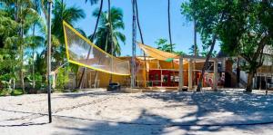 a net in the sand in front of a building at Soul Breeze Beach Resort in Diani Beach +23 photos