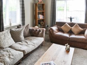 a living room with a couch and a coffee table at Lyndhurst in Longhorsley