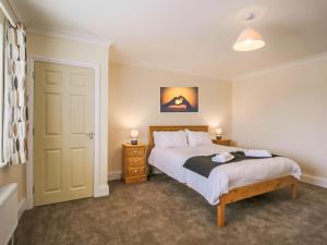 a bedroom with a large bed and two night stands at 2 Dawson Court - Uk33411 in Mablethorpe