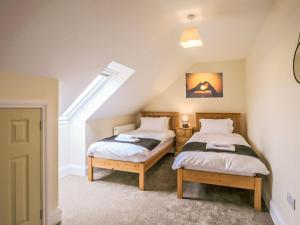 two beds in a room with a attic at 2 Dawson Court - Uk33411 in Mablethorpe