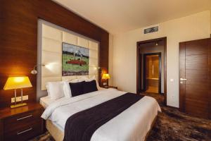 a bedroom with a large bed in a hotel room at Costé Hotel in Tbilisi City