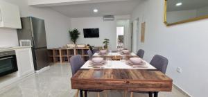 a kitchen and dining room with a wooden table and chairs at Sal Casa VILLAGE in Santa Maria