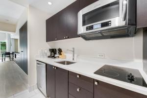 a kitchen with a sink and a microwave at Provident Doral at the Blue Miami in Miami +4 photos