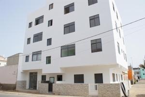 a white building on the side of a street at Sal Casa VILLAGE in Santa Maria