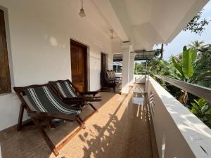 two chairs on the balcony of a house at Maya Residency in Alleppey