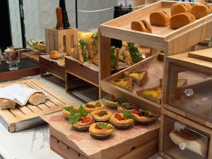 a display case with various types of bread and pastries at Atour Hotel ShanghaiPeople's Square Xintiandi Subway in Shanghai