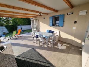 a patio with a table and chairs and a cat at Luna's Seaview Residence - Ankaran in Ankaran