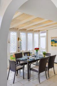 a dining room with a table and chairs at 3BR Tauro Bungalow - Garden, Terrace, Sleeps 6 in Mogán +18 photos