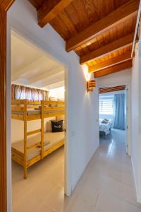 a hallway with bunk beds in a house at 3BR Tauro Bungalow - Garden, Terrace, Sleeps 6 in Mogán