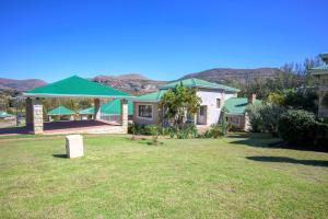 a house with a green roof in a yard at 156 on Clarens in Clarens +5 photos