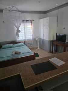 Postel nebo postele na pokoji v ubytování Diani Cozy Garden Studio