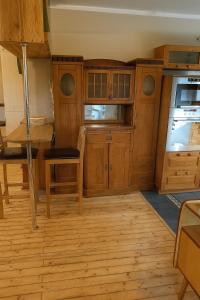 a kitchen with wooden cabinets and a refrigerator at Avar ja mugav korter kesklinna lähedal in Tartu +7 photos