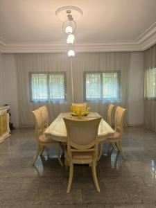 a dining room with a table and chairs at Nomad Living Bacodjicoroni in Bamako