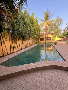 a swimming pool in the middle of a courtyard at Nomad Living Bacodjicoroni in Bamako