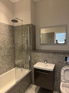 a bathroom with a shower and a sink and a toilet at Paramount Stays - Uxbridge in Uxbridge