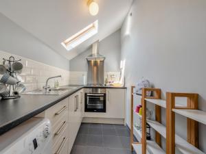 a kitchen with a sink and a stove at West Llwyn - Uk41757 in Rhyd Owen +12 photos