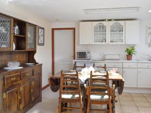 a kitchen with a table and chairs in a kitchen at Low Cordorcan - Uk5891 in Bargrennan