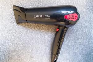 a black hair dryer sitting on top of a table at Cozy 1-Bedroom in Central Oullins Steps from the Metro in Oullins