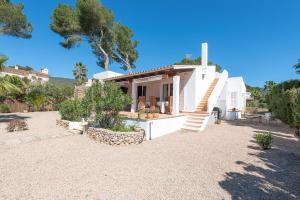 a white house with a staircase in a yard at House Beach & Golf Costa de los Pinos in Costa des Pins
