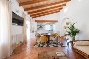a living room with a table and chairs at House Beach & Golf Costa de los Pinos in Costa des Pins