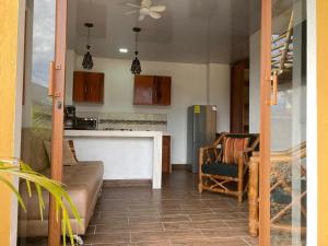 a living room with a couch and a kitchen at Shakai suite in Tena