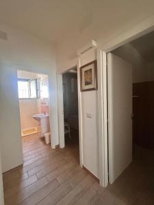 an empty room with a hallway with a bathroom at Pearl Apartment - Baia Verde in Baia Verde