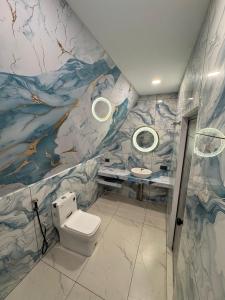 a bathroom with a toilet and a sink at Inara By BR Homes in Trivandrum
