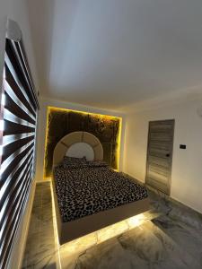 a bedroom with a bed in a room with a fireplace at Inara By BR Homes in Trivandrum
