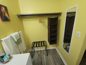 a bathroom with a chair and a mirror and towels at Fox Mountain Inn in Max Meadows +25 photos