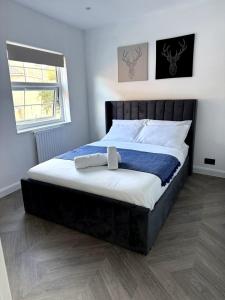 a bedroom with a large bed with a black headboard at Cosy Central Colchester Home by Castle Park in Colchester