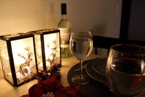 ロヴァニエミにあるA cozy Scandinavian condo in the city centerのワイングラスとワイン1本付きのテーブル