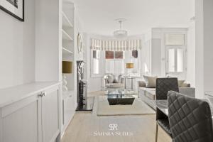 a living room with a couch and a table at New Stylish 4BR - Windsor City Centre - Sleeps 6 in Windsor +22 photos