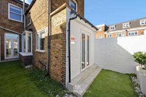 a brick house with a wooden walkway leading to the door at New Stylish 4BR - Windsor City Centre - Sleeps 6 in Windsor