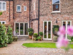 a brick building with a courtyard with potted plants at The Lodge in York
