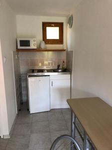 a small kitchen with a sink and a microwave at PäRLAN APARTMAN in Balatonboglár