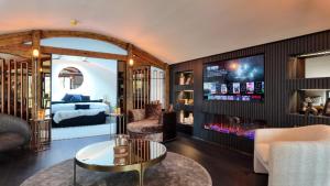 a living room with a fireplace and a bedroom at The Penthouse in Dungiven
