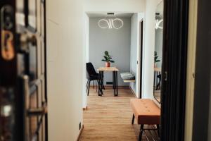 a hallway with a table and chairs in a room at Lake View stay, stunning sunrises & free parking in Liepāja +21 photos