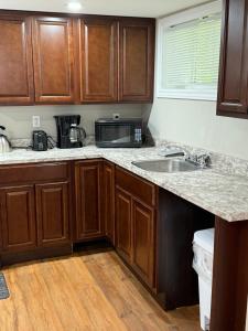a kitchen with a sink and a microwave at Vinnecomb Apartments - Lower Floor - 2 Bedroom in St. John's +13 photos