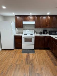 a kitchen with a white stove and a refrigerator at Vinnecomb Apartments - Lower Floor - 2 Bedroom in St. John's