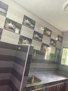 a kitchen with black and white striped walls and a sink at LAkSHMI HOMESTAY in Tirupati +64 photos