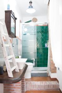 a bathroom with a toilet and a glass shower at SicilyStudio Apartment in Taormina-Murmuria Minerva in Taormina
