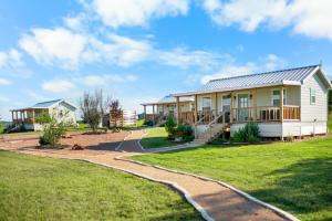 a house with a walkway in front of it at Laurel Court Cottages- A Pickleball Getaway in Fredericksburg