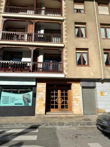 a tall building with windows and balconies on it at Apartamento El Ferial in Potes