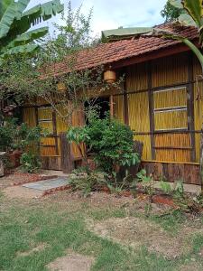 a small house with a fence and a yard at Coffee Homestay A Vũ in Kon Cho Dri +9 photos