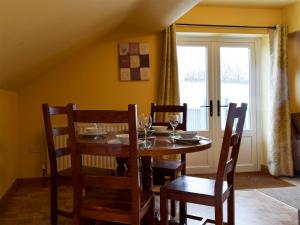 a dining room with a table and chairs and a window at Fennel Folly - Uk32608 in Manton