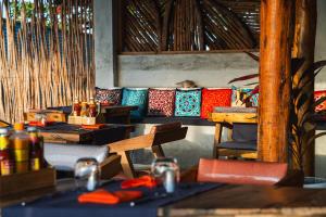 a group of tables and chairs in a room at Dhow Beach Boutique Hotel in Nungwi
