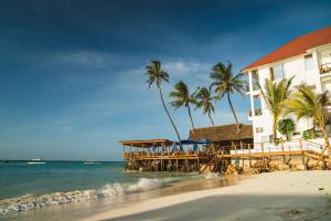 a resort on the beach with palm trees and the ocean at Dhow Beach Boutique Hotel in Nungwi +41 photos