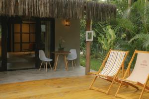 a patio with chairs and a table in front of a house at CASA SUKHA Hotel in Trancoso