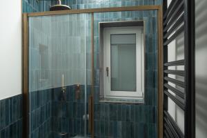 a bathroom with a mirror and a shower at Amira Ca' Argento Premium Apartments in Trieste Center in Trieste